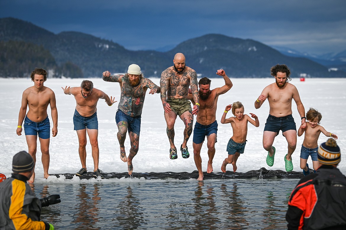 Participants leap into Whitefish Lake during the Penguin Plunge on Saturday, Feb. 5. Organized by the Law Enforcement Torch Run as part of the Whitefish Winter Carnival, the event raised over $60,000 for Special Olympics Montana. (Casey Kreider/Daily Inter Lake)