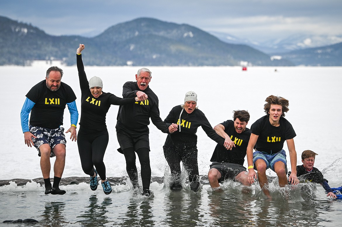 Participants leap into Whitefish Lake during the Penguin Plunge on Saturday, Feb. 5. Organized by the Law Enforcement Torch Run, as part of the Whitefish Winter Carnival, the event raised over $60,000 for Special Olympics Montana. (Casey Kreider/Daily Inter Lake)