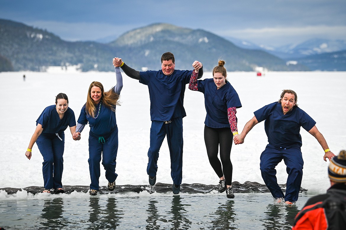 Participants leap into Whitefish Lake during the Penguin Plunge on Saturday, Feb. 5. Organized by the Law Enforcement Torch Run, as part of the Whitefish Winter Carnival, the event raised over $60,000 for Special Olympics Montana. (Casey Kreider/Daily Inter Lake)