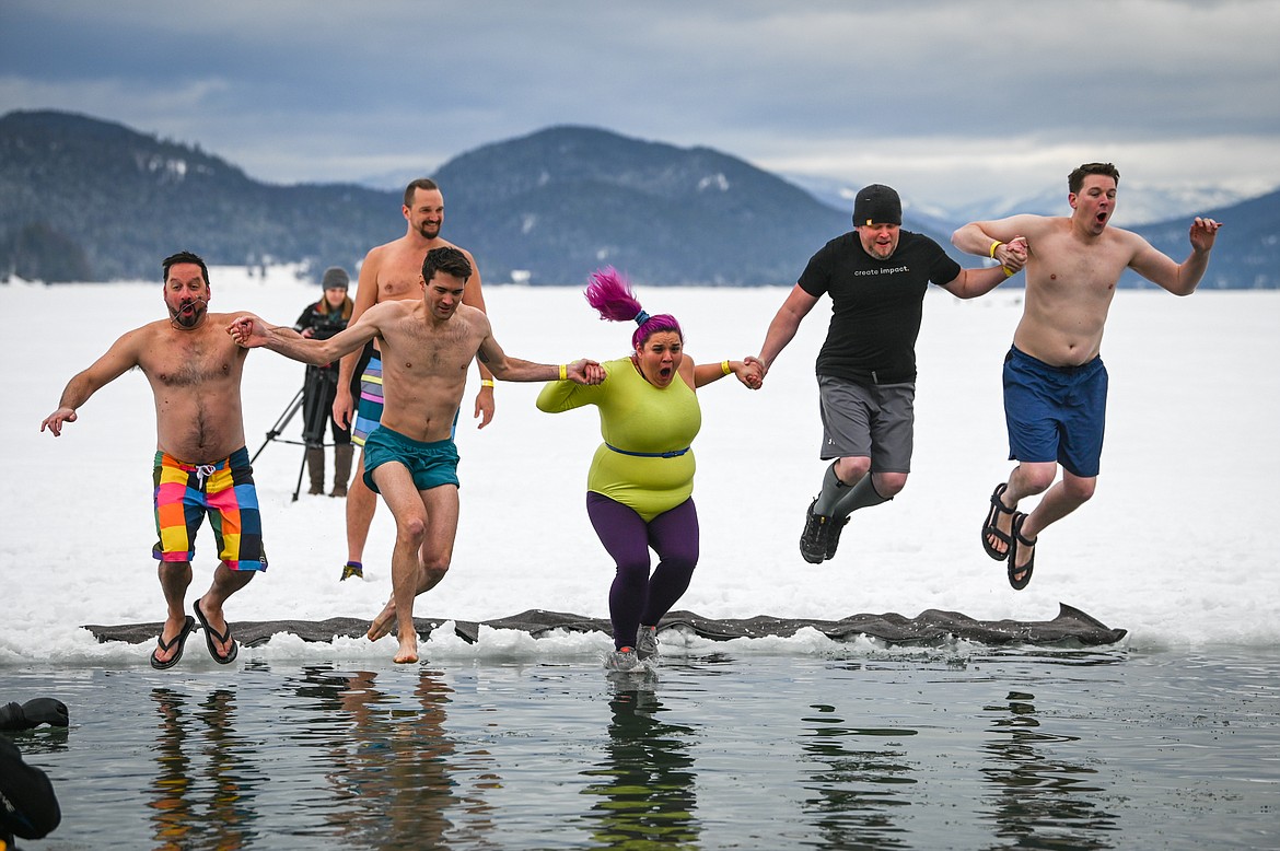 Participants leap into Whitefish Lake during the Penguin Plunge on Saturday, Feb. 5. Organized by the Law Enforcement Torch Run, as part of the Whitefish Winter Carnival, the event raised over $60,000 for Special Olympics Montana. (Casey Kreider/Daily Inter Lake)