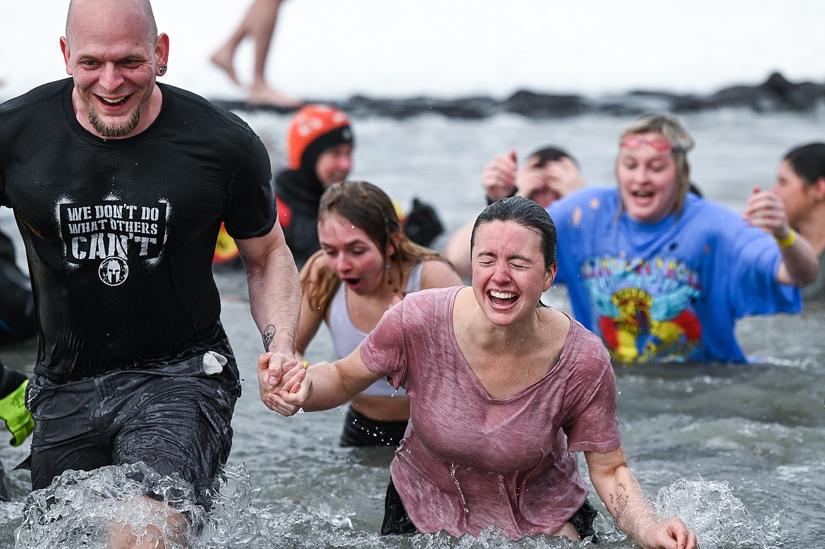 Participants step out of Whitefish Lake during the Penguin Plunge on Saturday, Feb. 5. Organized by the Law Enforcement Torch Run as part of the Whitefish Winter Carnival, the event raised over $60,000 for Special Olympics Montana. (Casey Kreider/Daily Inter Lake)