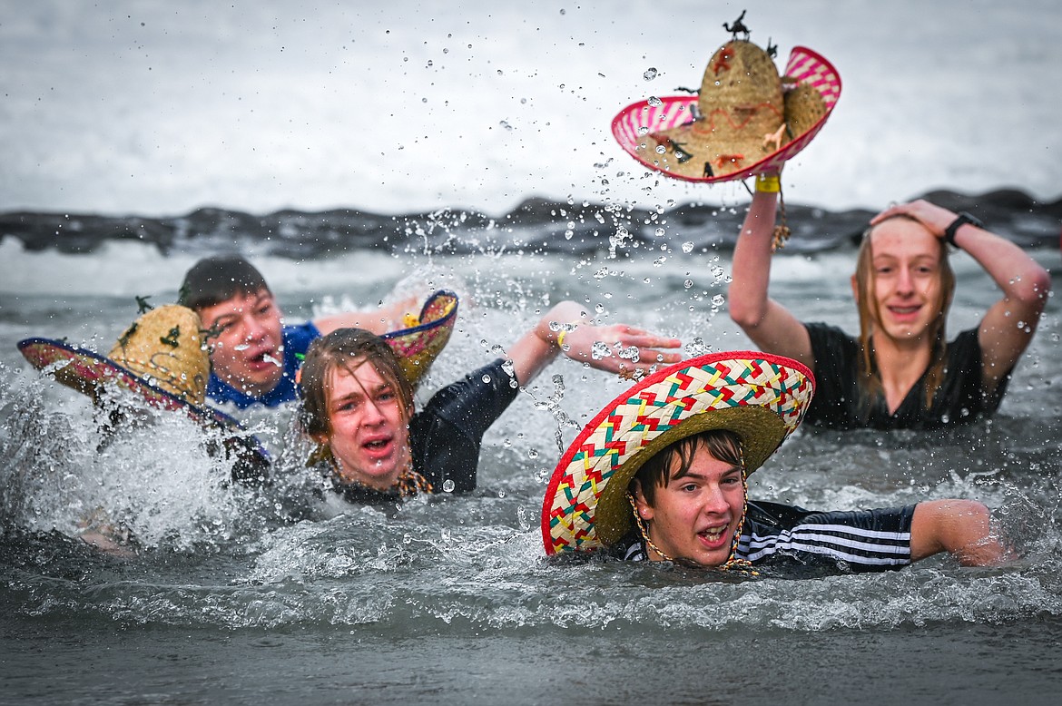 Participants swim out of Whitefish Lake during the Penguin Plunge on Saturday, Feb. 5. Organized by the Law Enforcement Torch Run as part of the Whitefish Winter Carnival, the event raised over $60,000 for Special Olympics Montana. (Casey Kreider/Daily Inter Lake)