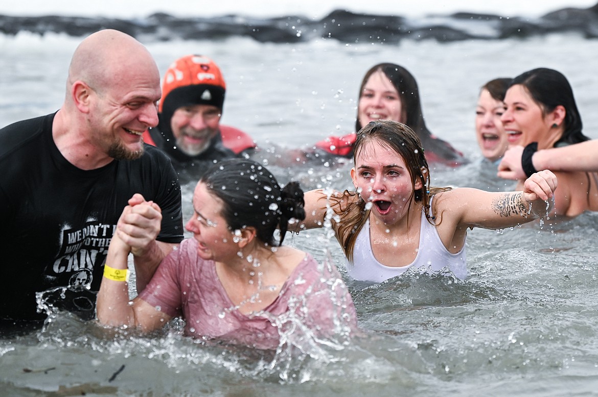 Participants step out of Whitefish Lake during the Penguin Plunge on Saturday, Feb. 5. Organized by the Law Enforcement Torch Run as part of the Whitefish Winter Carnival, the event raised over $60,000 for Special Olympics Montana. (Casey Kreider/Daily Inter Lake)