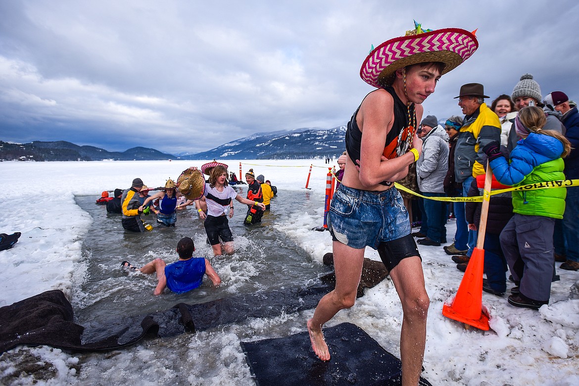 Participants step out of Whitefish Lake during the Penguin Plunge on Saturday, Feb. 5. Organized by the Law Enforcement Torch Run as part of the Whitefish Winter Carnival, the event raised over $60,000 for Special Olympics Montana. (Casey Kreider/Daily Inter Lake)