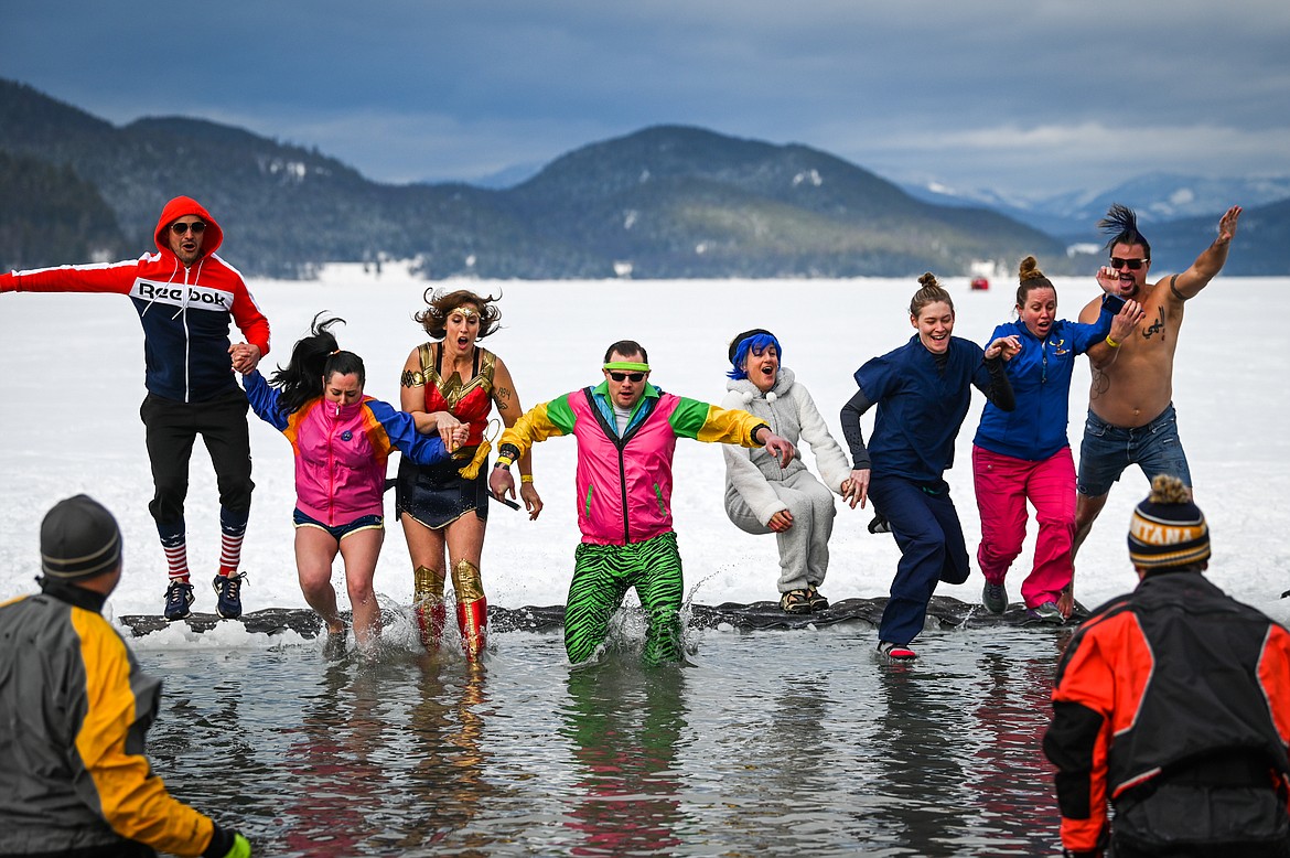 Participants leap into Whitefish Lake during the Penguin Plunge on Saturday, Feb. 5. Organized by the Law Enforcement Torch Run, as part of the Whitefish Winter Carnival, the event raised over $60,000 for Special Olympics Montana. (Casey Kreider/Daily Inter Lake)