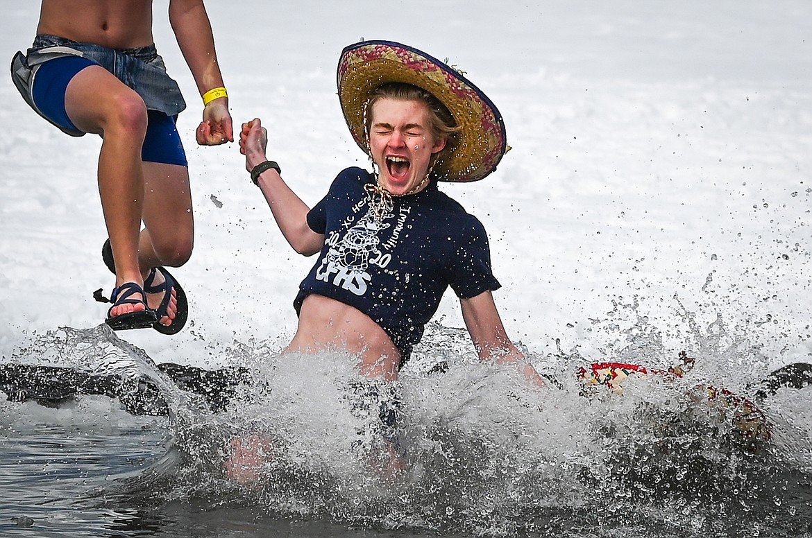 Participants leap into Whitefish Lake during the Penguin Plunge on Saturday, Feb. 5. Organized by the Law Enforcement Torch Run as part of the Whitefish Winter Carnival, the event raised over $60,000 for Special Olympics Montana. (Casey Kreider/Daily Inter Lake)