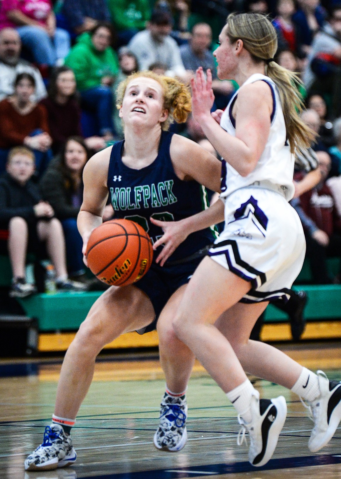 Glacier's Reese Ramey (23) drives to the basket against Butte's Pieper Joseph (12) at Glacier High School on Saturday, Feb. 5. (Casey Kreider/Daily Inter Lake)