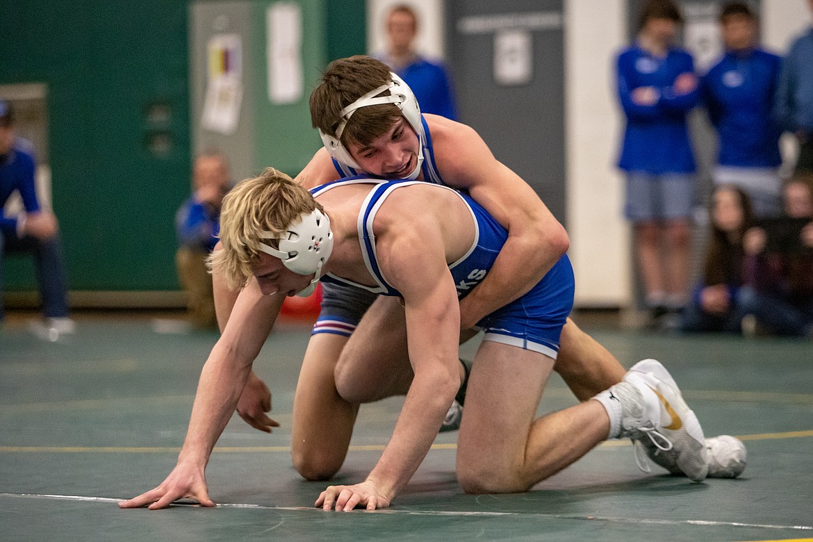 Columbia Falls wrestler Justin Windauer, top, grapples with Thompson Falls standout Trae Thilmony on Jan. 27. (photo by JP Edge/Hungry Horse News)