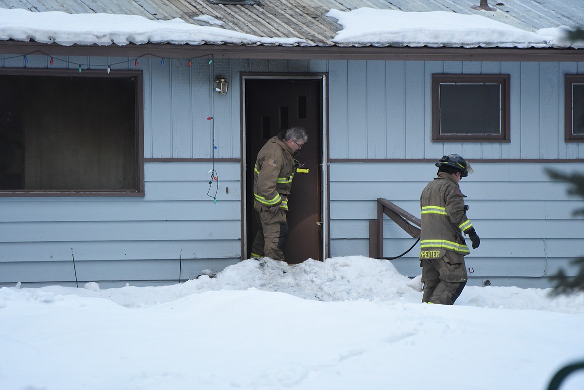 Fire Chief Steve Lauer, left, investigates the scene of a Feb. 5 house fire on Bald Eagle Road. (Derrick Perkins/The Western News)