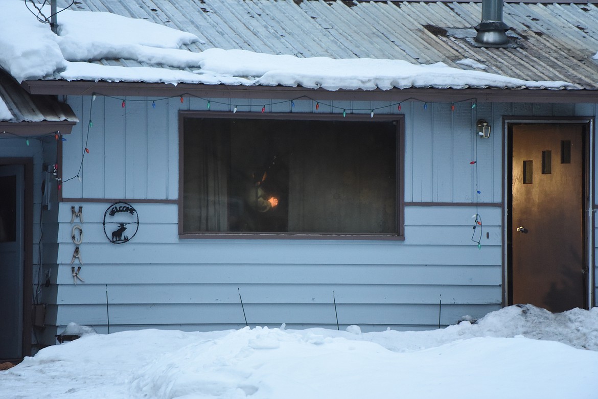 Investigators examine the interior of a house following a Feb. 5 blaze on Bald Eagle Road. (Derrick Perkins/The Western News)