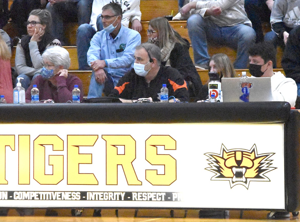 Ryan Shannon, center, watches a game as the announcer for Ephrata High School basketball.