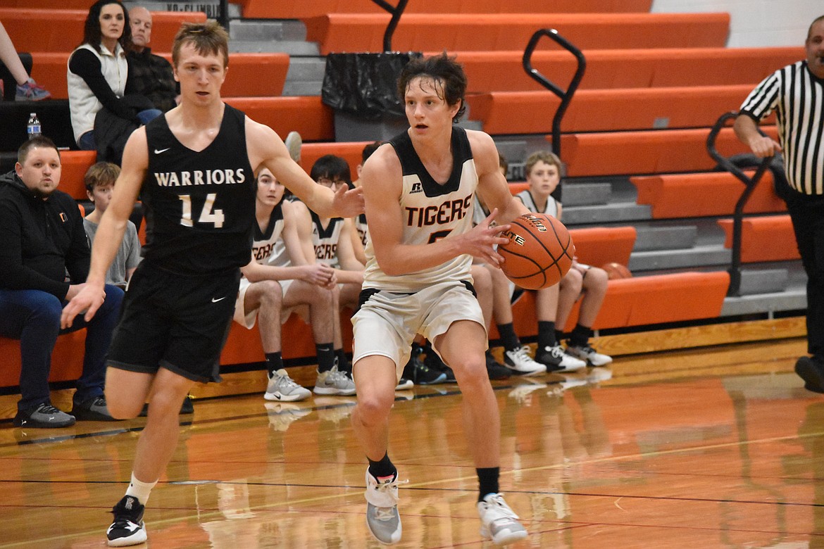 Odessa High School junior Collin Martin (5) drives past Almira/Coulee-Hartline High School senior Parker Roberts (14) during the match on Thursday.