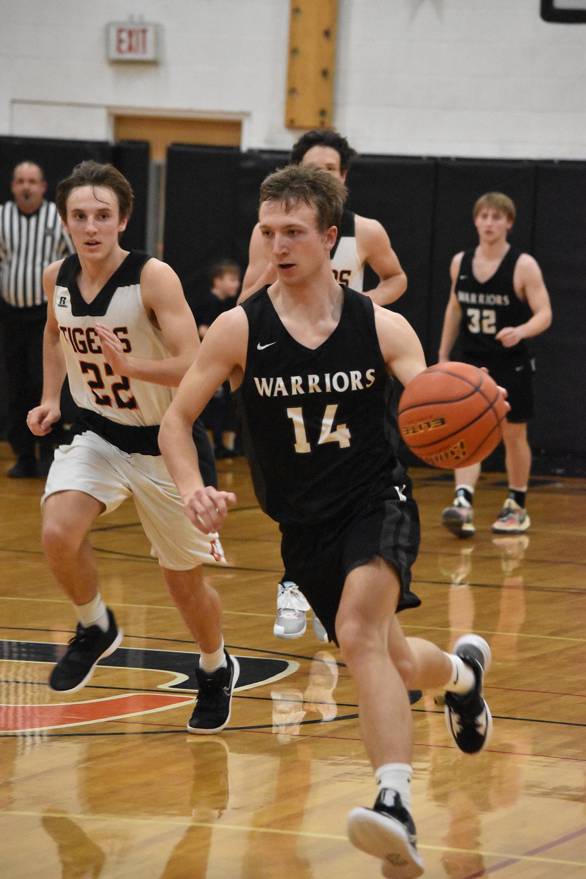 Almira/Coulee-Hartline High School senior Parker Roberts (14) heads for the hoop during the game against Odessa High School on Thursday.