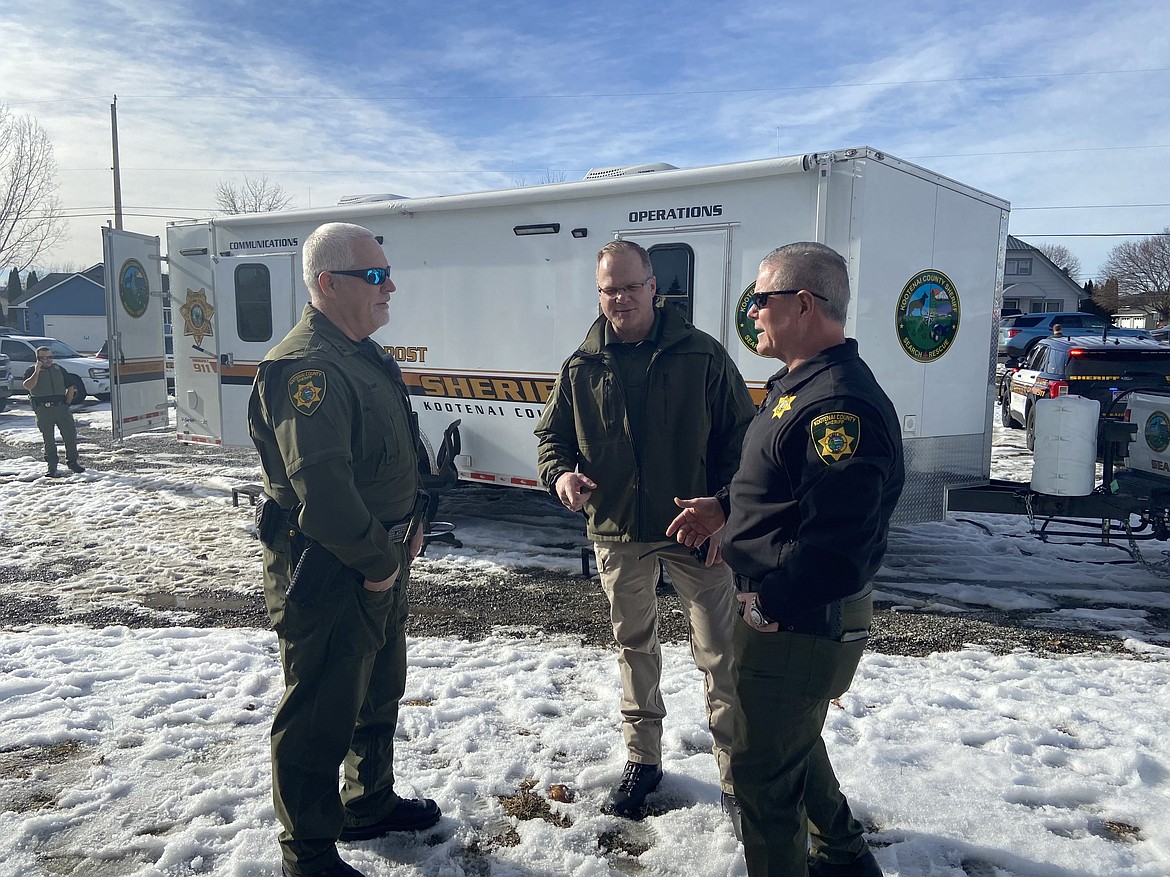 From left, Capt. Kevin Smart and Capt. Brett Nelson confer with Kootenai County Sheriff Bob Norris at the scene of a hostage situation Sunday afternoon in Hayden.