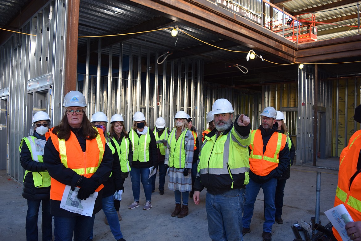 CBRE-Heery Project Manager Brian Sewell tells Vanguard Academy staff about the concessions shop, which will be located on the first floor of Vanguard Academy. Staff are standing in a flex area, which will be both a hallway and a place for student assemblies and other presentations.