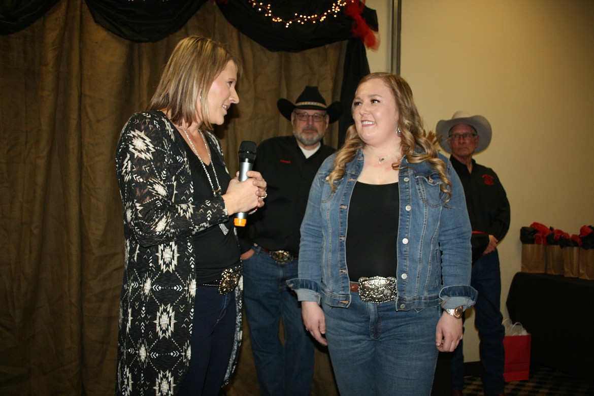 Jill Tonne, left, recognizes 2020-21 Miss Moses Lake Roundup Queen Mykiah Hollenbeck, right, during the Columbia Basin Rodeo Association Banquet on Saturday.