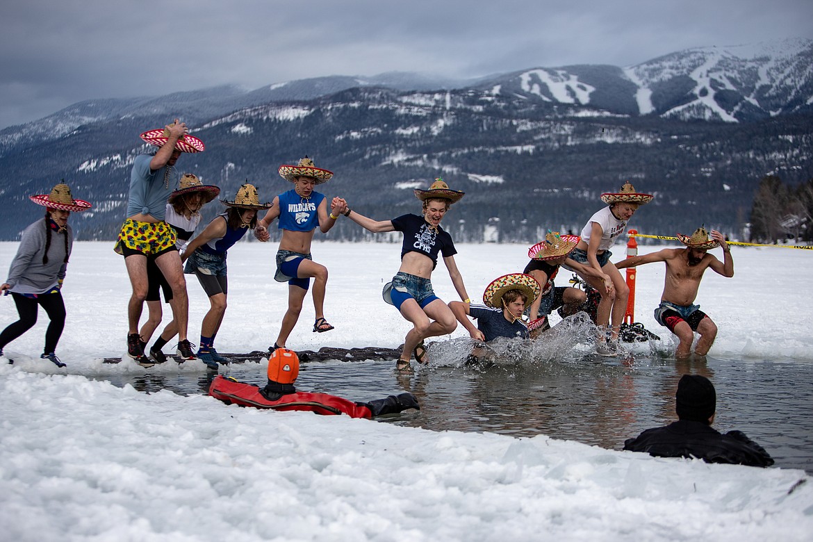 The Columbia Falls High School track team gets wet at the Penguin Plunge in Whitefish Lake on Feb. 5. (JP Edge photo)