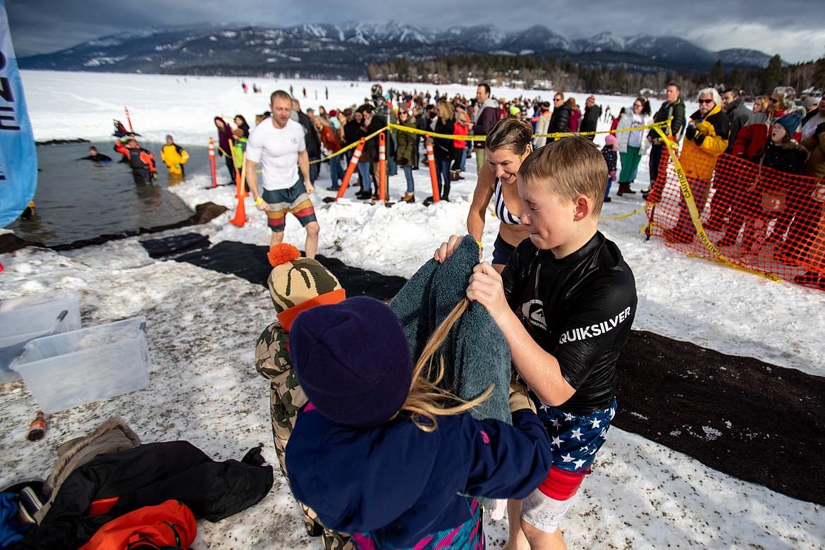 A young Penguin Plunge participant moments after submerging in the frozen lake Saturday morning. (JP Edge photo)