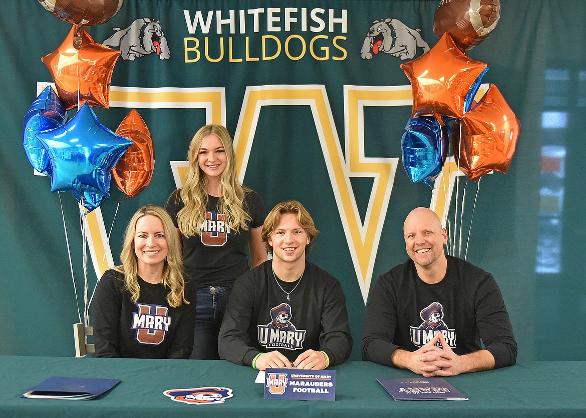 Whitefish High School senior Jaxsen Schlauch recently signed a letter of intent to play football at the University of Mary. He is pictured here with his parents Cari and Brian Schlauch and sister Saylor. (Whitney England/Whitefish Pilot)