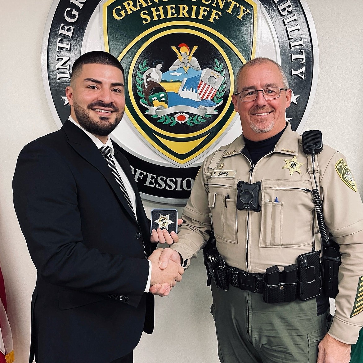 Grant County Sheriff Tom Jones, right, shakes hands with GCSO Deputy Hector Ledezma, left, after swearing in the new deputy on Jan. 10. Jones said the department is working on hiring more than a dozen staff for patrol or jail positions.