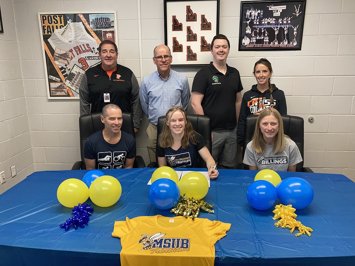 Courtesy photo
Post Falls High senior Alahna Lien recently signed a letter of intent to compete on the triathlon team at Montana State University-Billings. Seated from left are Jeff Lien, Alahna Lien and Sheila Lien; and standing from left, Chris Sensel (Post Falls High principal), Brian Trefry (Post Falls High cross country coach, David Dolphay (Coeur d'Alene Area Swim Team coach) and Jessie Ward (Post Falls High assistant cross country coach).