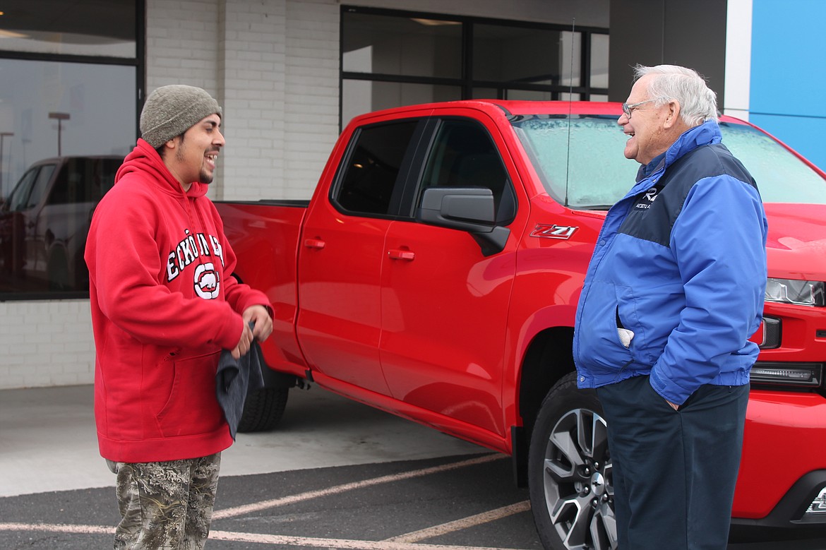 Ray Mayo, right, talks with fellow Bud Clary Toyota of Moses Lake employee Javier Barajas, left, at the car lot on Friday.