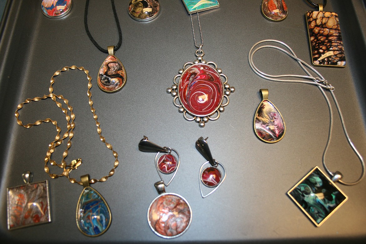 Necklaces, earrings and pendants fill a tray in the Moses Lake studio of acrylic artist Phyllis PuFahl.