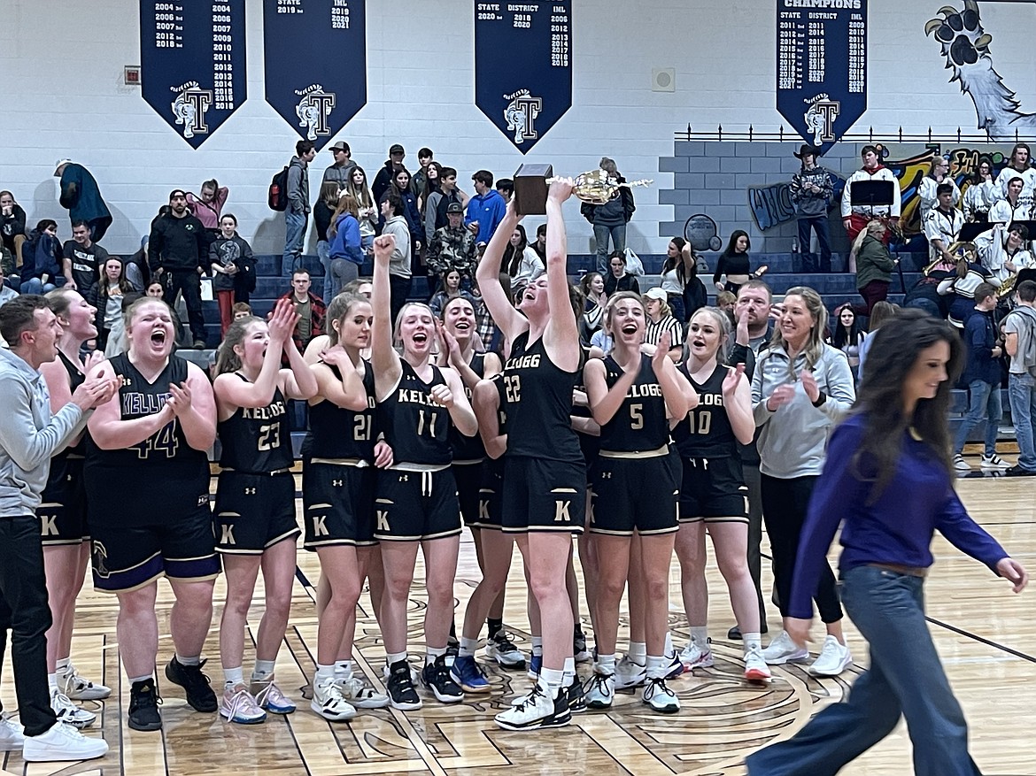 MARK NELKE/Press
Senior Hailey Cheney (22) holds the trophy aloft after the Kellogg Wildcats beat the Timberlake Tigers on Tuesday night in Spirit Lake in the 3A District 1 girls basketball championship game.