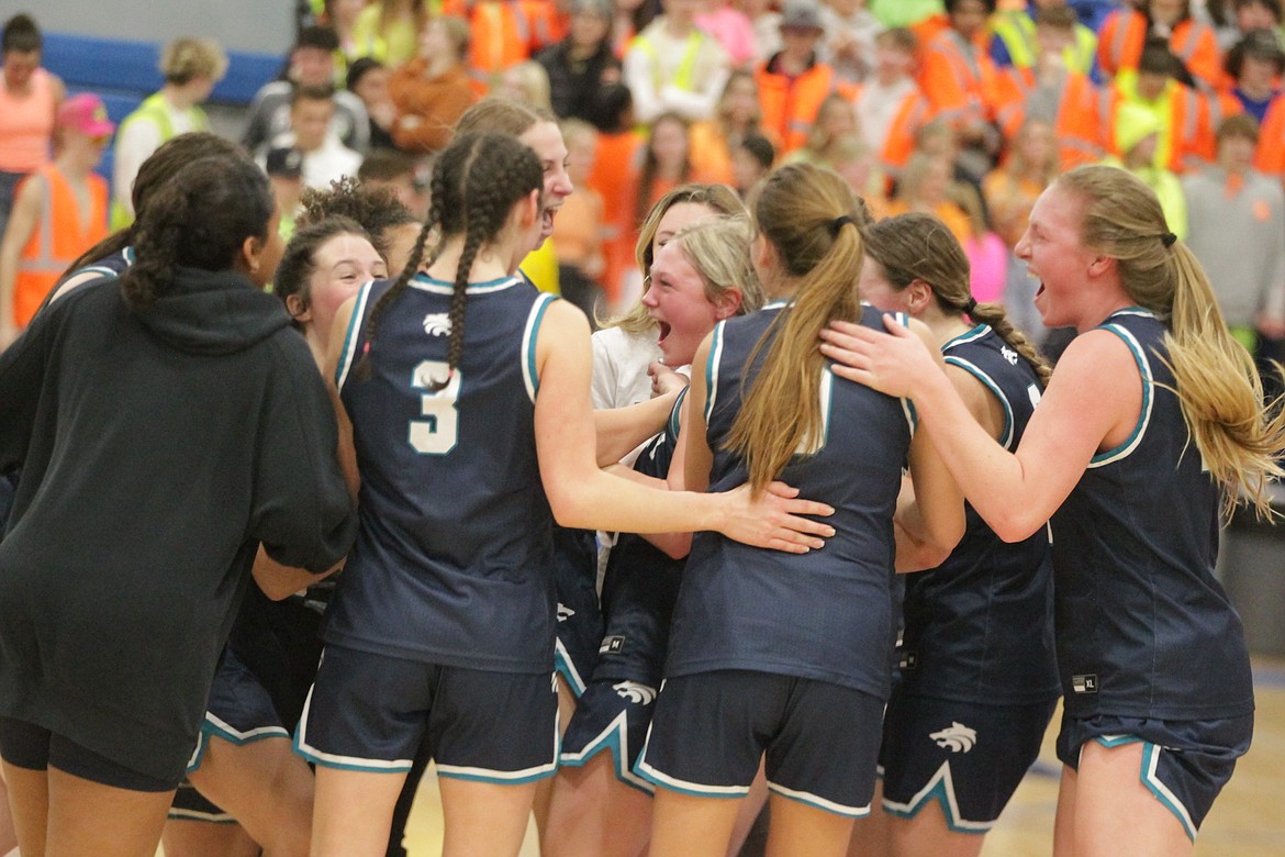 JASON ELLIOTT/Press
Lake City sophomore guard Olivia Zufelt, center, celebrates with the rest of her teammates following the Timberwolves 63-57 win over the Coeur d'Alene Vikings in the 5A Region 1 girls basketball championship game at Viking Court.