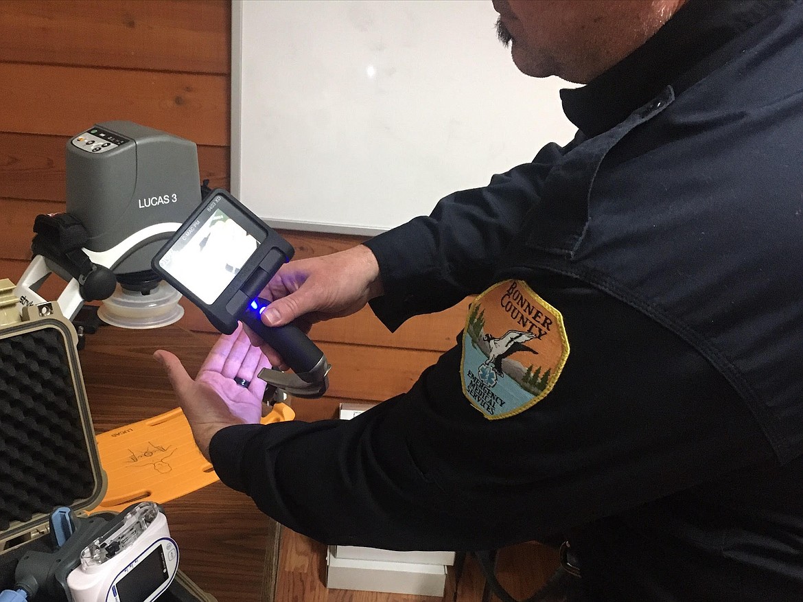 Emergency Medical Services Director Jeff Lindsey demonstrates how the department's new laryngoscopes function. Laryngoscopes assist medical workers with inserting g-tubes. Lindsey holds his hand in front of the portion that is inserted into an individual's body, the feed is then displayed on the screen attached to the opposite end of the laryngoscope.