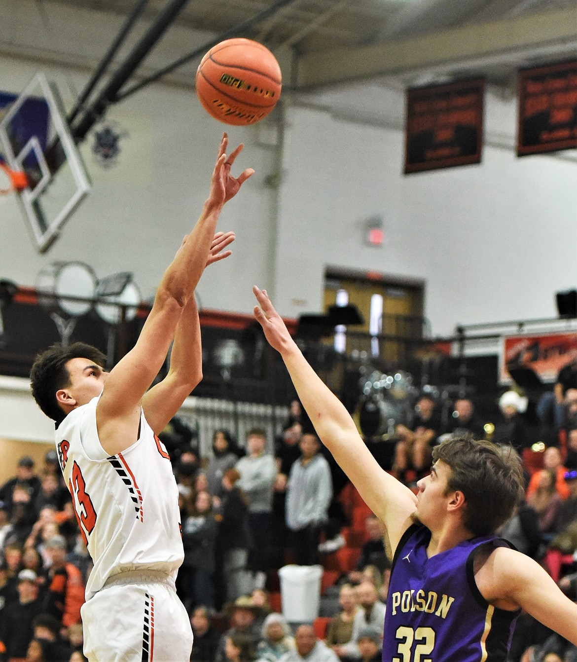 Ruben Couture shoots a jumper over Polson's Colton Graham. (Scot Heisel/Lake County Leader)