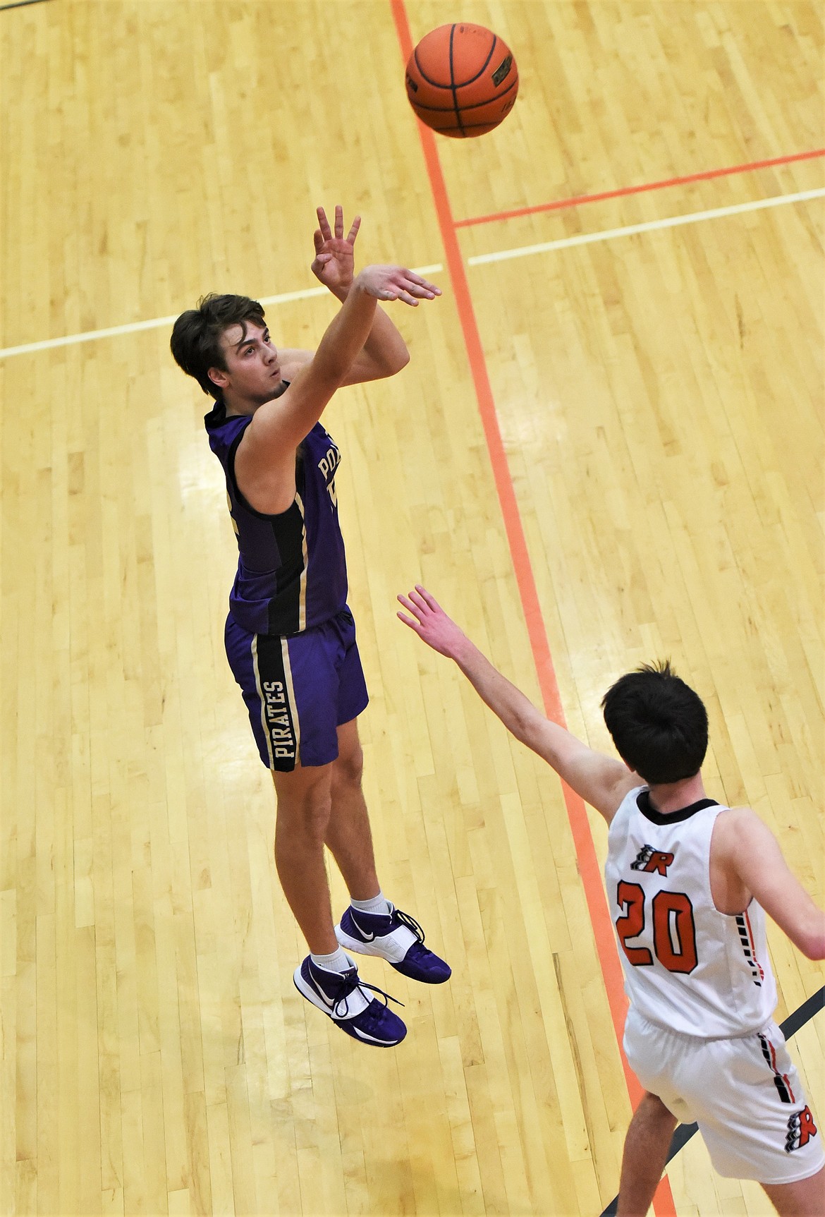 Polson's Colton Graham fires off a 3-pointer in front of Ronan's Ted Coffman. (Scot Heisel/Lake County Leader)