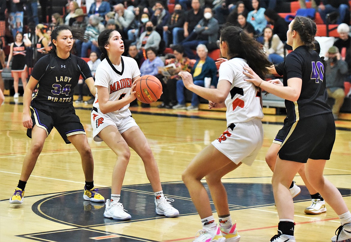 Ronan's LaReina Cordova lines up a shot in front of teammate Leina Ulutoa and Polson's Turquoise Pierre (34) and Mckenna Hanson (40). (Scot Heisel/Lake County Leader)