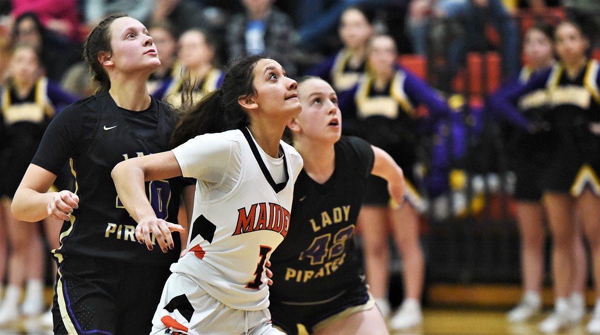 Ronan's Leina Ulutoa looks for a rebound in front of Polson's Mckenna Hanson, left, and Grace Simonich. (Scot Heisel/Lake County Leader)