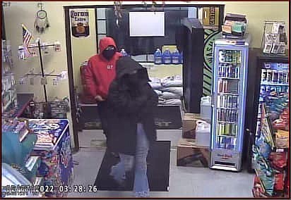 Investigators are seeking information to locate the two individuals shown in this photo. The pair are suspects in an armed robbery at the Country Travel Plaza in Lind on Monday.