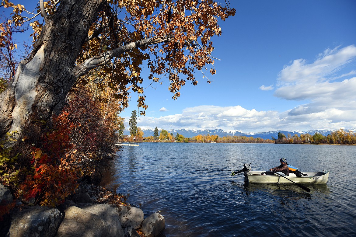 Steven Gundersen, of Hamilton, paddles out onto Church Slough along the Flathead River with his dog Freya on Wednesday, Oct. 23. (Casey Kreider/Daily Inter Lake)