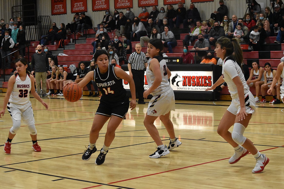 Ephrata High School sophomore Alessa Soto (14) drives to the hoop past several Othello High School opponents in the district playoff game on Tuesday.