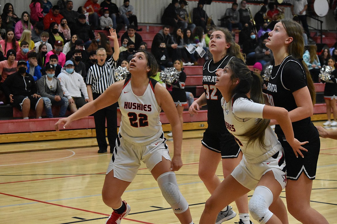 Othello High School juniors Briana Andrade (22) and Annalee Coronado (4) block Ephrata High School opponents, senior Hayden Mills (32) and sophomore Addison Mills (30), in an attempt to rebound the basketball on Tuesday.