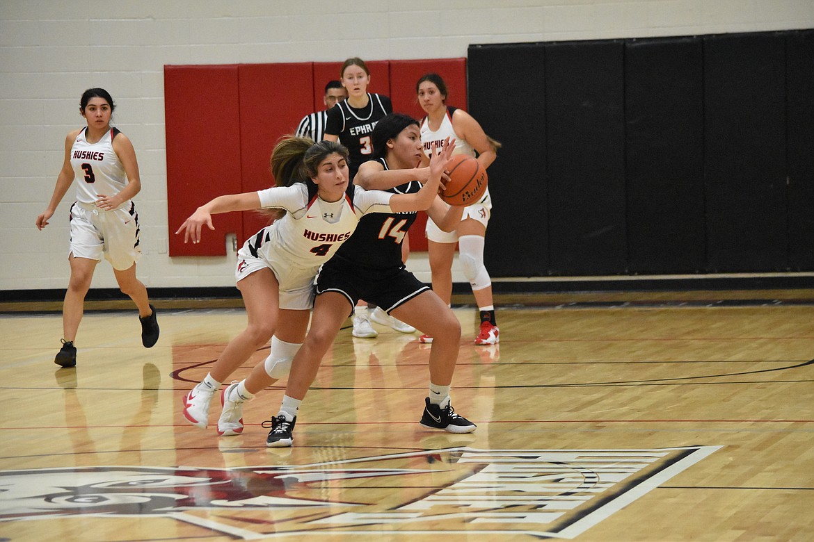 Othello High School junior Annalee Coronado (4) attempts to steal the ball from Ephrata High School sophomore Alessa Soto (14) on Tuesday.