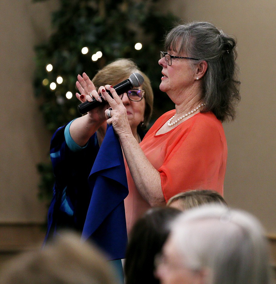 Barbara Turner of Coeur d'Alene asks a question as Beverly Guenette holds the mic Thursday during a meeting of the Kootenai County Republican Women Federated.