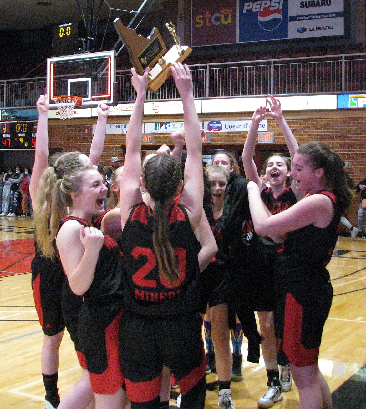 MARK NELKE/Press
Jaden House (20) of Wallace holds up the trophy after the Miners beat Lakeside to win the 1A Division I District 1 girls basketball championship Thursday night at North Idaho College.