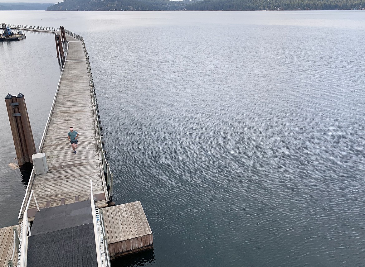 A man takes a run around The Boardwalk near The Coeur d'Alene Resort earlier this year.