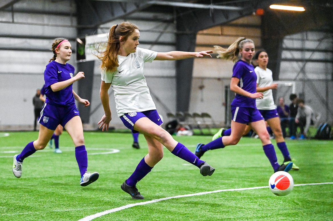 NSC 05/06G White's Mauraia Nigon (17) scores a goal against NSC 05/06G Purple at the Montana Indoor Soccer Championship tournament at the Flathead County Fairgrounds Trade Center building on Friday, Feb. 11. (Casey Kreider/Daily Inter Lake)