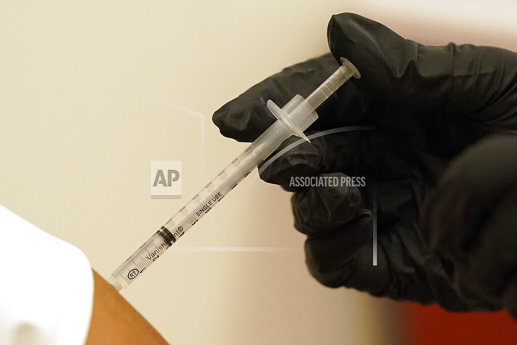 A person is injected with her second dose of the Pfizer COVID-19 vaccine at a Dallas County Health and Human Services vaccination site in Dallas, Thursday, Aug. 26, 2021. Federal health regulators on Friday, Feb. 11, 2022 delayed next week's public meeting to review Pfizer’s COVID-19 vaccine for children under 5, saying they want to see more data. (AP Photo/LM Otero, File)