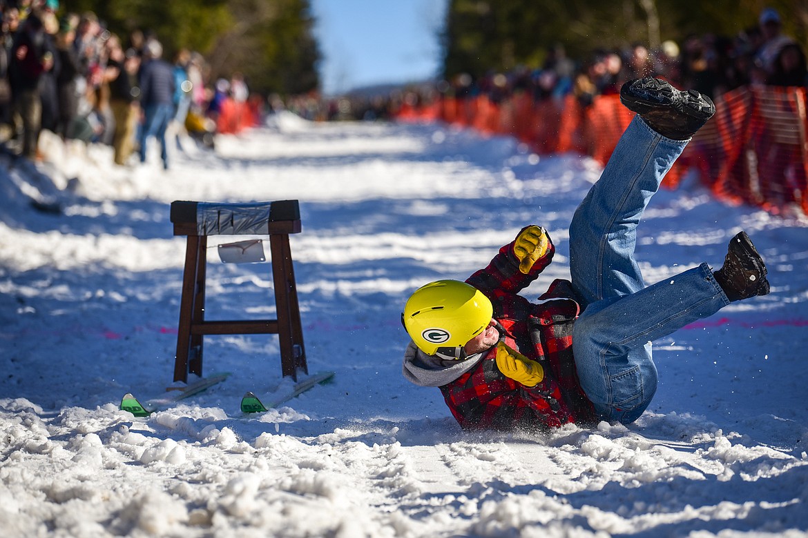 A competitor falls off his barstool as he crosses the finish line at the Barstool Ski Races at the 43rd annual Cabin Fever Days in Martin City on Saturday, Feb. 12. (Casey Kreider/Daily Inter Lake)