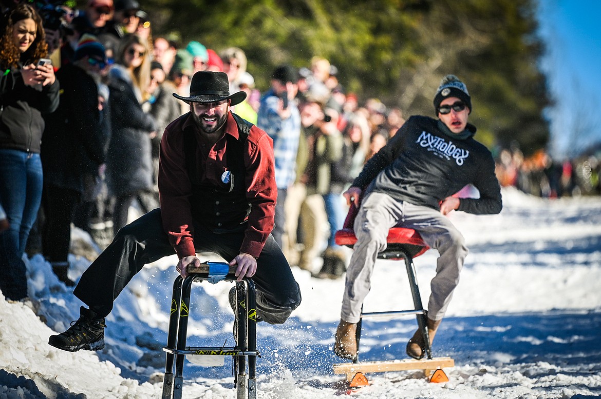 Chronicles of Barnia, left, races Jonny Highfill during the Barstool Ski Races at the 43rd annual Cabin Fever Days in Martin City on Saturday, Feb. 12. (Casey Kreider/Daily Inter Lake)
