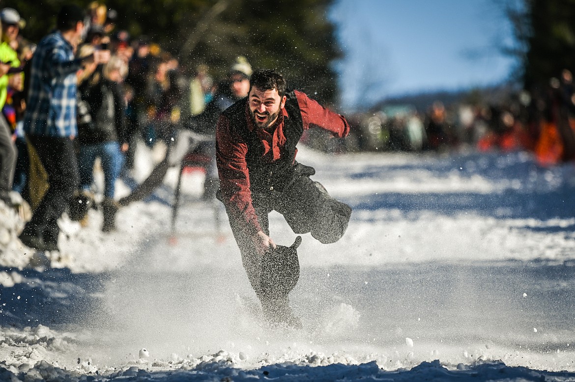 Chronicles of Barnia tries to stay on his feet after he lost his barstool racer at the Barstool Ski Races during the 43rd annual Cabin Fever Days in Martin City on Saturday, Feb. 12. (Casey Kreider/Daily Inter Lake)