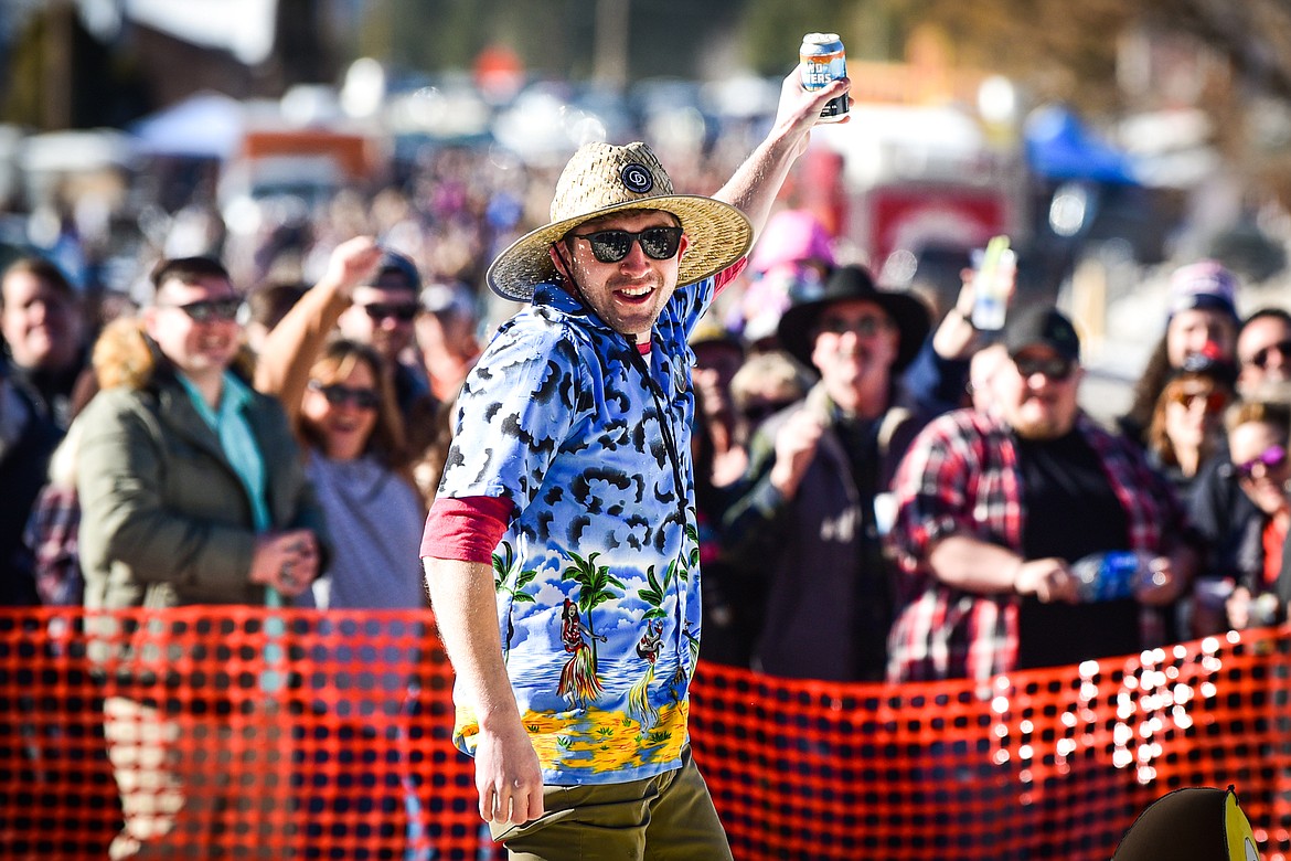 A competitor holds up his beer after crossing the finish line at the Barstool Ski Races at the 43rd annual Cabin Fever Days in Martin City on Saturday, Feb. 12. (Casey Kreider/Daily Inter Lake)