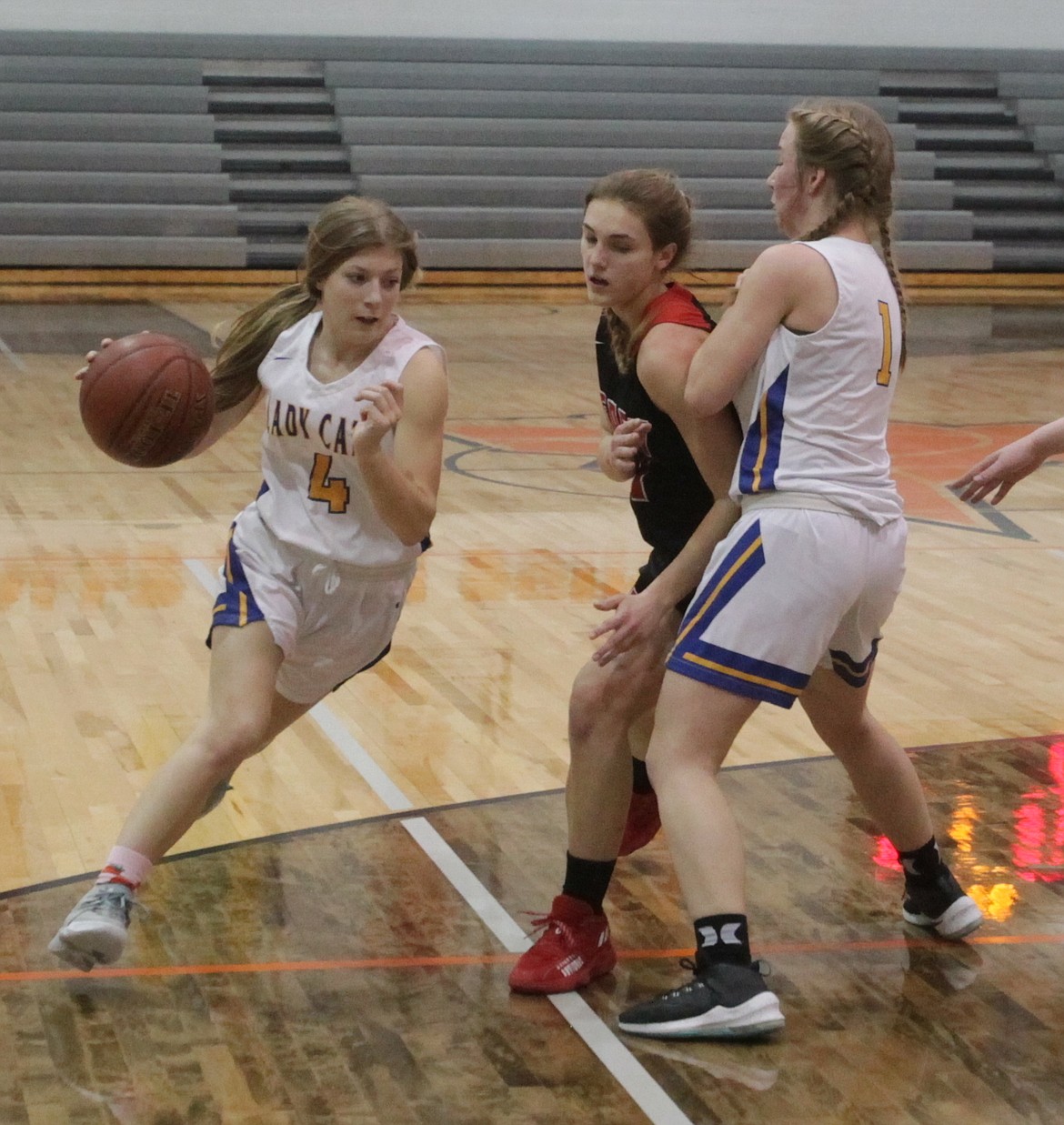 MARK NELKE/Press
Eloise Shelton (4) of Clark Fork uses a screen from Katelyn Matteson to drive to the basket in the first half against Deary in a state 1A Division II girls basketball play-in game Saturday at Post Falls High.