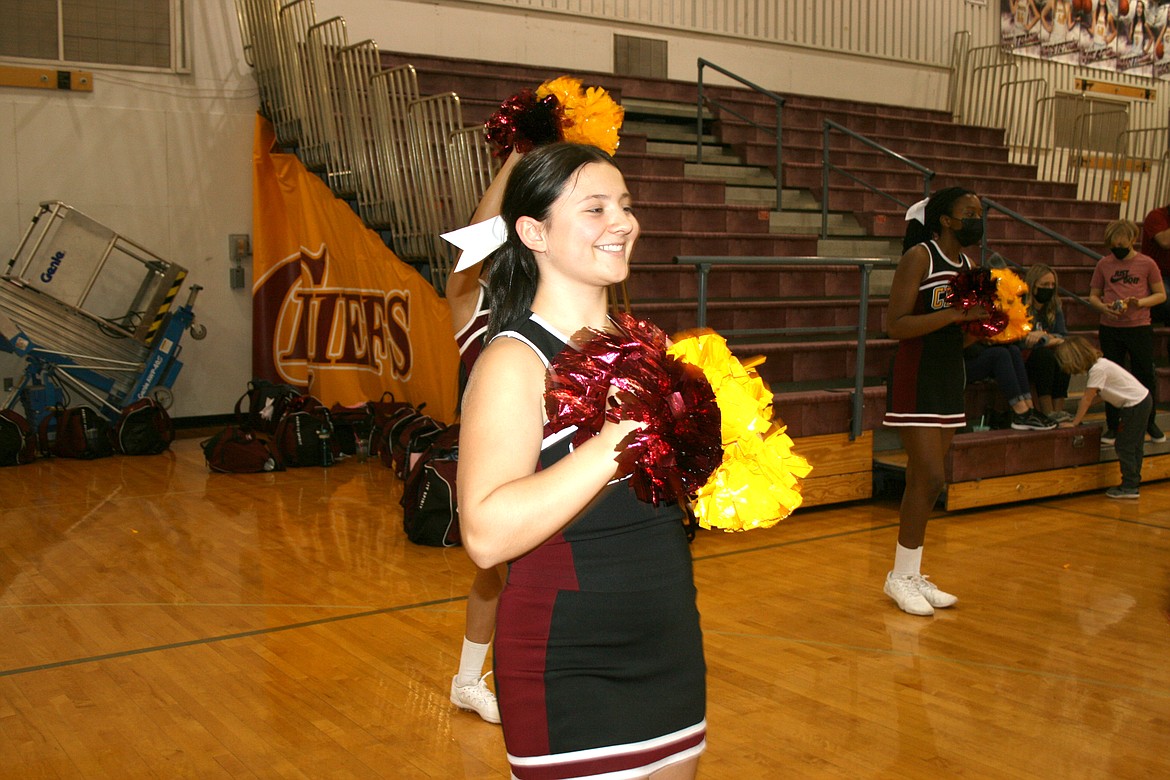 Moses Lake High School cheerleader Lily Schindler cheers on the unified teams from Moses Lake and Ephrata high schools during a game Feb. 9 at MLHS.